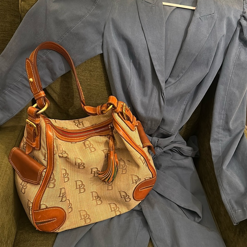 Vintage Dooney Bourke handbag with lots of leather, brass, tassels
